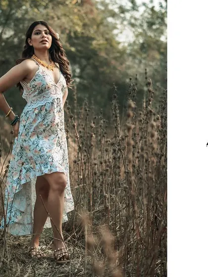 This full-length portrait captures the free-spirited feel of an outdoor fashion shoot. Set in a field with natural foliage, the image showcases the entire outfit in motion. This style is perfect for lifestyle brands or for a portfolio that needs to convey a relaxed, bohemian vibe.