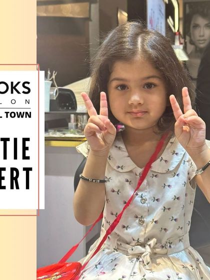 Peace out! This little client is feeling the good vibes after her salon visit, showing off her cute new hairstyle.