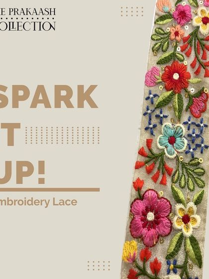 A vibrant, multi-colored floral embroidery lace shown on a light base. The detailed threadwork creates a garden of flowers, ideal for bringing life to plain fabrics or designing unique ethnic wear.