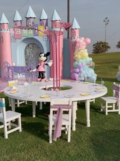 A closer view of the kids' seating area at the Mickey and Minnie party, with a custom circular table and character centerpiece.