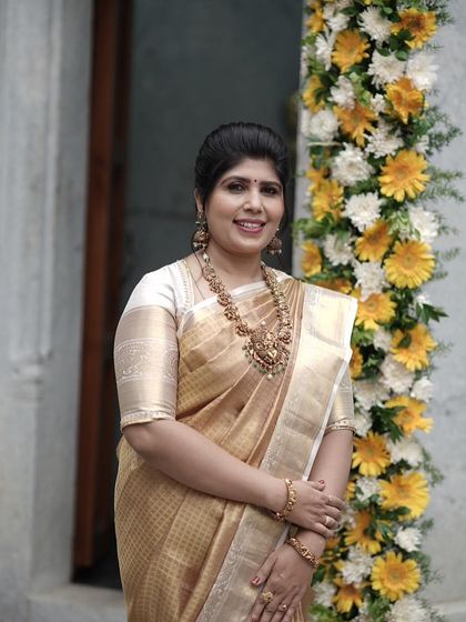 A happy portrait of Shilpa, her smile as bright as her golden saree.