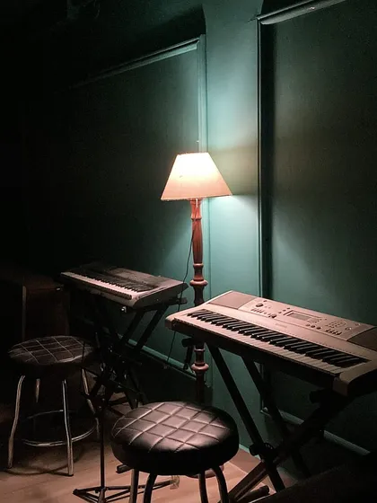 The quiet ambiance of our studio, with keyboards ready for the next lesson. We provide a calm and focused environment for learning.