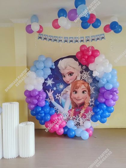 Another view of a Frozen themed party setup, highlighting the balloon columns and number "6" foil balloon.