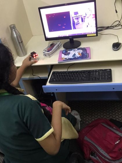 A student uses a sensor and camera to interact with an AI program she is developing. Our workshops provide hands-on experience with the hardware and software used in machine learning.