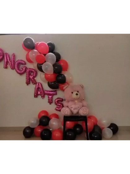 This is a close-up of the 'Congrats' balloon arrangement, showing the mix of foil and latex balloons used to create a celebratory corner.