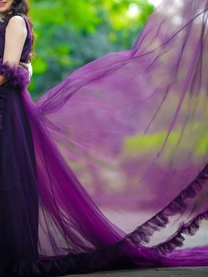 For a simple yet elegant look, this dark purple maternity gown with a long, flowing tail is a perfect choice.
