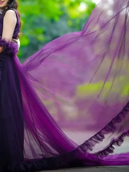 For a simple yet elegant look, this dark purple maternity gown with a long, flowing tail is a perfect choice.