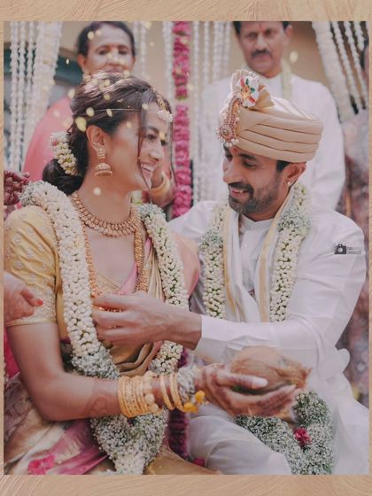 A candid moment of joy and affection between the couple during their wedding rituals.
