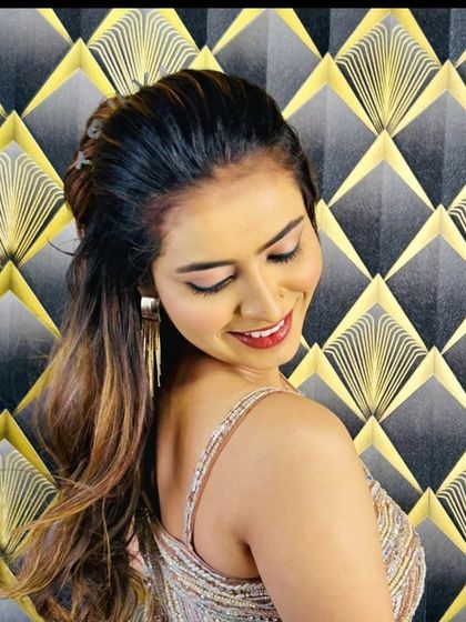 A side profile showing the model's hairstyle and the back of the gown.