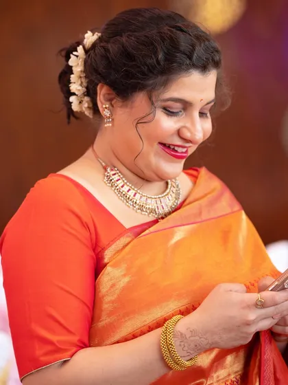 A candid moment of happiness. The makeup looks fresh and radiant even in a candid shot.