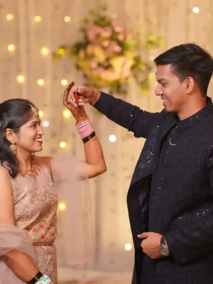 A sweet moment during the couple's first dance at their engagement party. The fairy lights in the background add a magical bokeh effect.