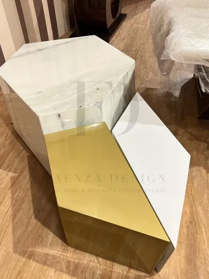 A set of geometric, nesting coffee tables. The trio includes one in white marble, one in a gold finish, and one in white Duco paint, allowing for a versatile and modern arrangement.