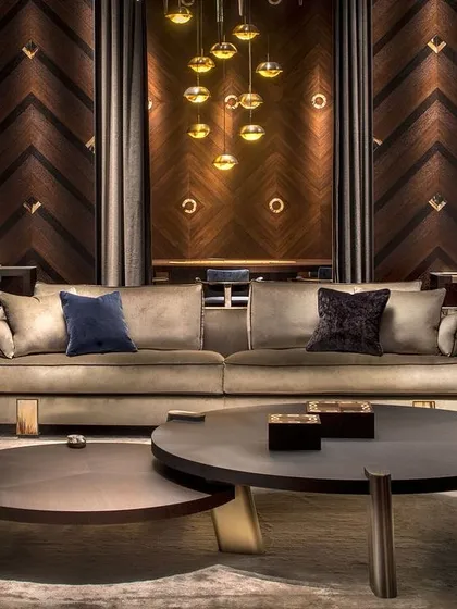 Defined by simple geometric lines, the striking elegance of these two nested coffee tables is in the rich details. A stately round oak veneer top sits atop three brass slanted rectangular feet.