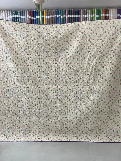 The patterned backing of the hexagon quilt.