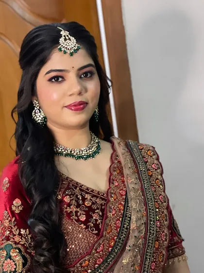 A modern reception look with a velvet lehenga. The makeup is glamorous with defined eyes and a bold lip.