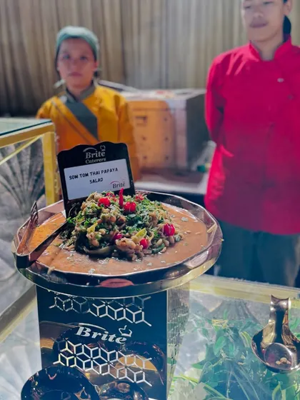 The classic Som Tom Thai Papaya Salad, freshly prepared at a live station, offering a perfect balance of sweet, sour, and spicy flavors.