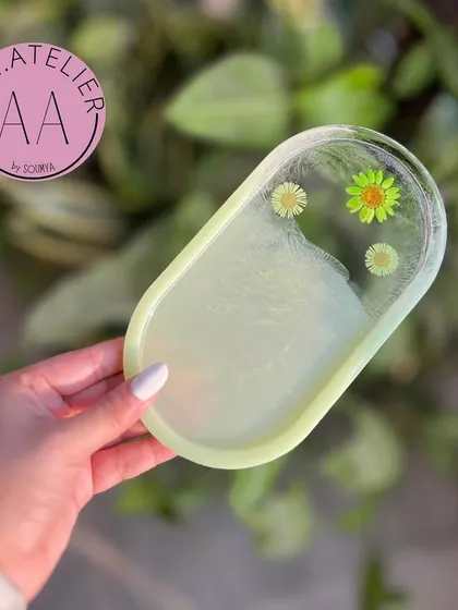 This pastel yellow-green oval trinket tray has a fresh and subtle charm. It's perfect for holding small items on your desk or vanity.