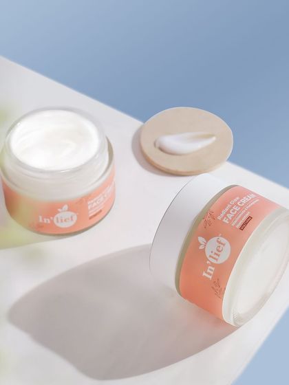 An open jar of In'lief face cream showing the smooth texture of the product inside. This kind of detail shot helps build customer trust by showing exactly what's inside the packaging.