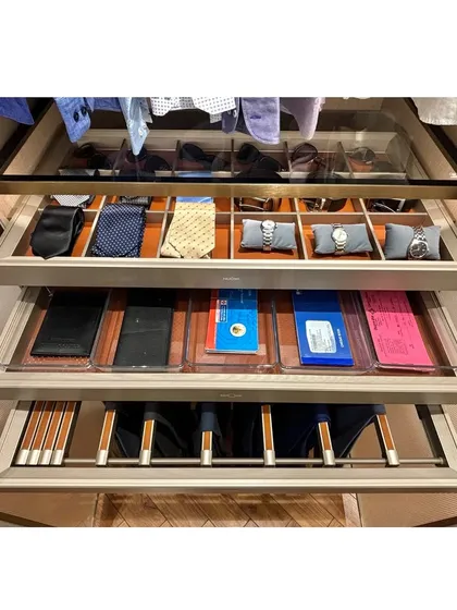 This multi-drawer system showcases comprehensive accessory organization, with dedicated spaces for ties, watches, wallets, and more.