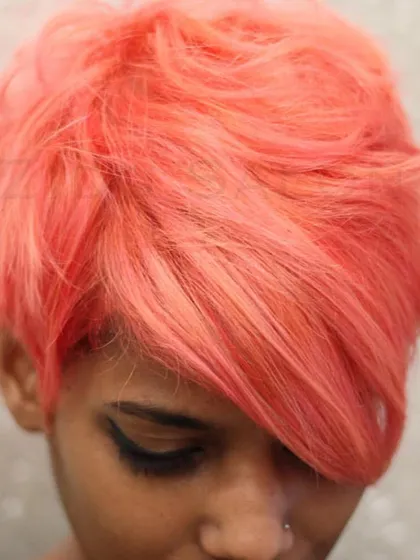 We mixed multiple shades to create this custom coral-pink for a short, textured pixie cut. This is a great example of how we can create a completely unique shade just for you.