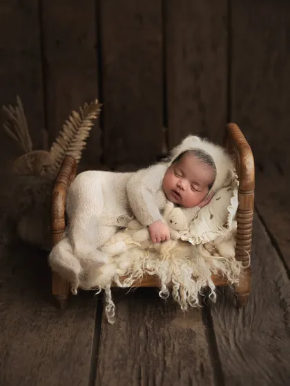 I have a collection of tiny, baby-safe wooden beds that create the most adorable scenes. This little one looks so peaceful sleeping in a cozy knit outfit on a bed of soft wool.