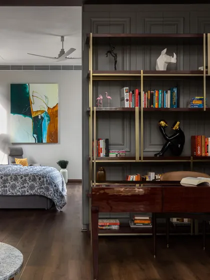 A view into the master suite, which includes a dedicated study area separated by a bespoke bookshelf. This design creates a functional and private workspace within the calm environment of the bedroom.