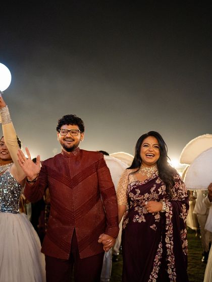 The couple's grand entrance, surrounded by their entourage, creating a magical and celebratory atmosphere.