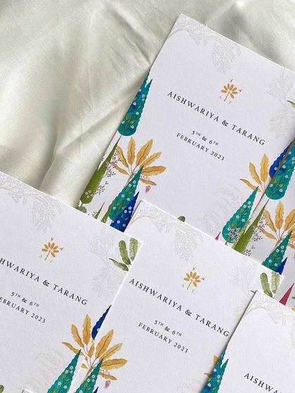 A stack of the illustrated welcome cards for the Champaner wedding. The vibrant and artistic design gives guests a beautiful keepsake of the celebration.