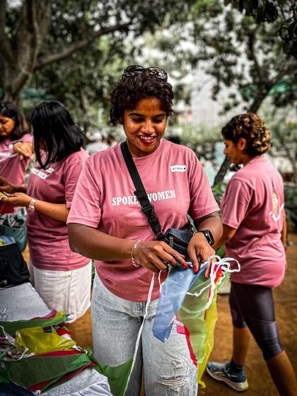 A volunteer in our pink 'Spokes Women' tee, busy helping out at the Garage Sale. Our community wear is practical for a day of activity.