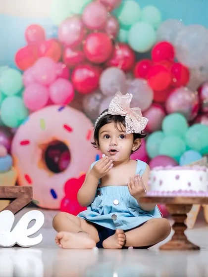 A sweet treat for a sweet girl. This first birthday studio session is a confection of giant donuts, macarons, and colorful balloons.