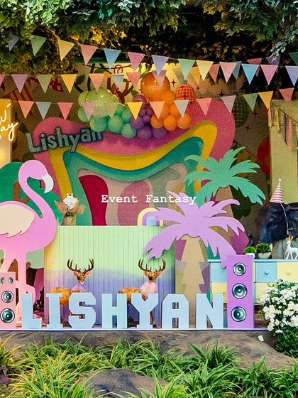 A fun and colorful setup for Lishyan's "Party Animal" birthday, featuring a large pink flamingo, speakers, and custom name blocks.