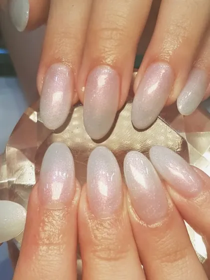 Simple but elegant. This beautiful manicure features a sheer, shimmery base with a soft glitter gradient for a delicate and sophisticated sparkle.