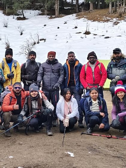 Our first Kedarkantha batch posing for a group photo at the campsite. The camaraderie and teamwork are essential for a successful and enjoyable trek.