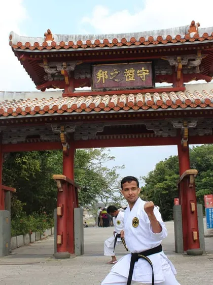 Practicing a fighting stance in front of the Shureimon gate at Shuri Castle in Okinawa. This location is deeply connected to the history of Okinawan martial arts, and it is an honor to practice there.