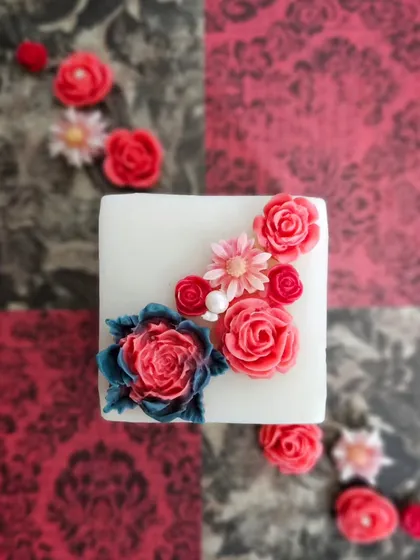 An overhead view of my Regal Pillar Candle, showcasing the detailed floral wax art on top. These are available in Rose Blossom and Fresh Lavender fragrances.