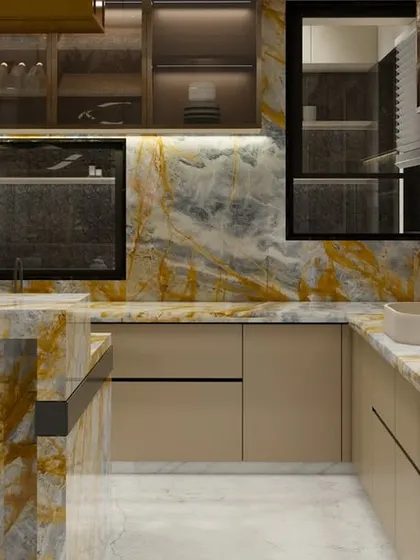 A close-up of a show kitchen designed for the realities of Indian cooking, featuring a breathtaking Italian marble with warm golden and yellow tones. This material is not only beautiful but also resilient against common stains, proving that luxury and practicality can coexist.