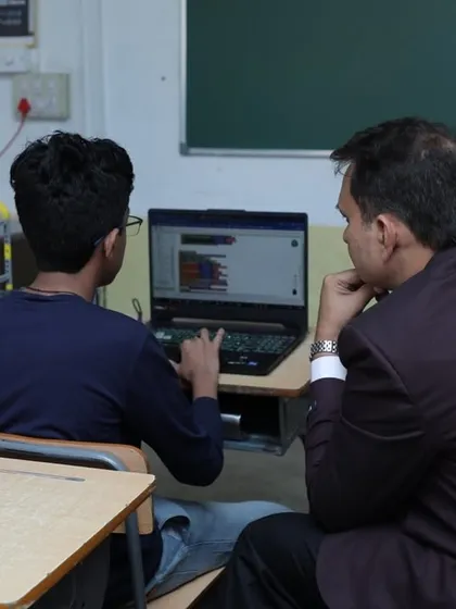 A student explains his code to our founder, Dhananjay Singh. We encourage deep understanding, ensuring students can articulate the logic behind their creations.