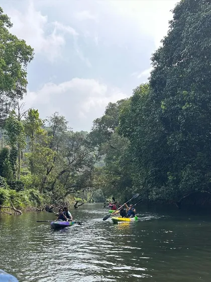 Kayaking in the calm river waters near our Kumara Parvatha base.
