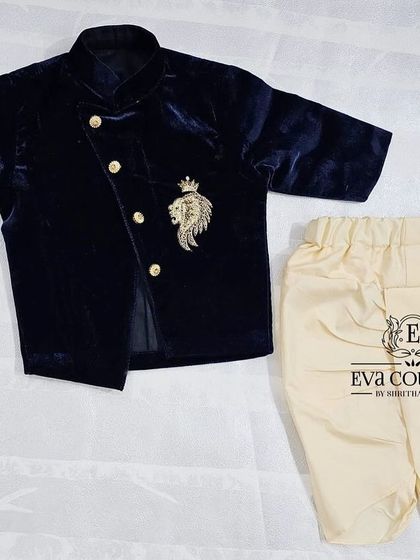 A stylish navy blue velvet jacket with a lion crest embroidery. This can be paired with a kurta and dhoti for a royal look, perfect for newborns.