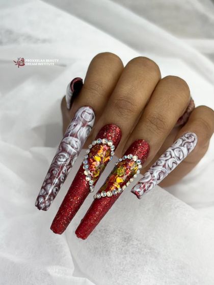 Another view of this romantic and bold nail set, showcasing the sparkling details and long, coffin shape.