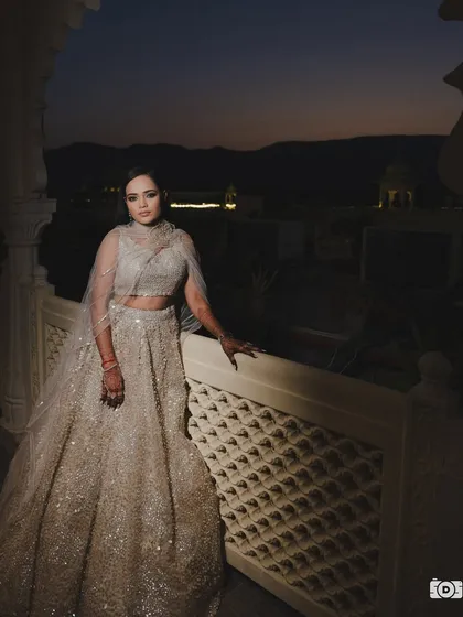 A dramatic and beautiful shot of Shreya at her Sangeet. Her glowing makeup and glamorous silver lehenga look stunning against the twilight sky.