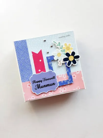 A sweet and simple farewell gift for a colleague. This mini scrapbook cover is personalized with their name, making it a thoughtful keepsake to remember shared moments and inside jokes.