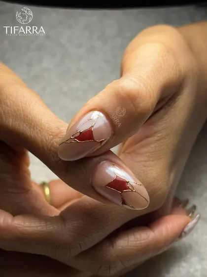 An abstract design featuring a shattered glass effect, with red fragments outlined in fine gold lines on a nude base.