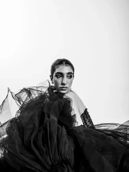 A close-up from the monochrome series. The focus is on the texture of the tulle and the model's melancholic, elegant expression.