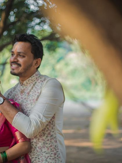 A playful, candid moment where the groom covers the bride's mouth as she laughs. It's these spontaneous interactions that reveal a couple's true dynamic.