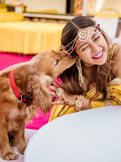 Our furry friends are family too. Capturing this bride sharing a joyful moment with her dog during the Haldi ceremony was incredibly special and shows how we can include all your loved ones.