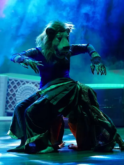A striking image of the Narasimha character, with dramatic lighting and smoke effects adding to the theatricality of the production.