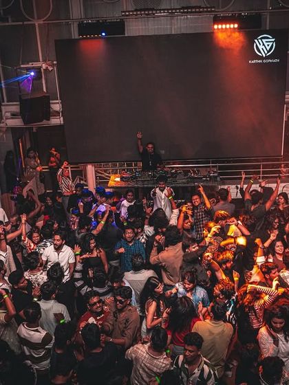 A high-angle shot of a packed house at Gypsy Tower. This perspective really shows the scale of the party and the number of people dancing.
