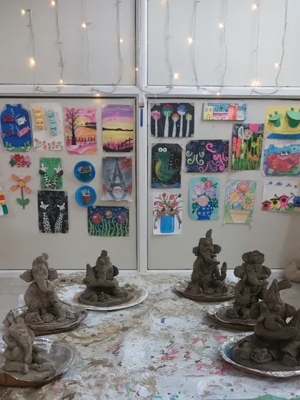 Our studio wall, adorned with children's artwork, provides a colorful backdrop for the newly made Ganesha idols. It's a beautiful display of ongoing creativity meeting festive tradition.