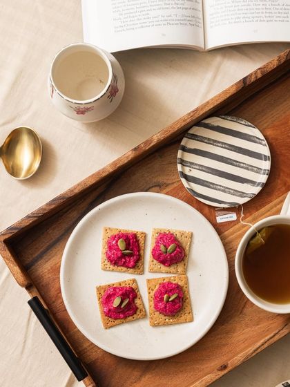 Unwind with a cup of tea and our wholesome beetroot crackers. Topped with a dollop of hummus, they make for a perfect light evening snack that's both crunchy and satisfying.